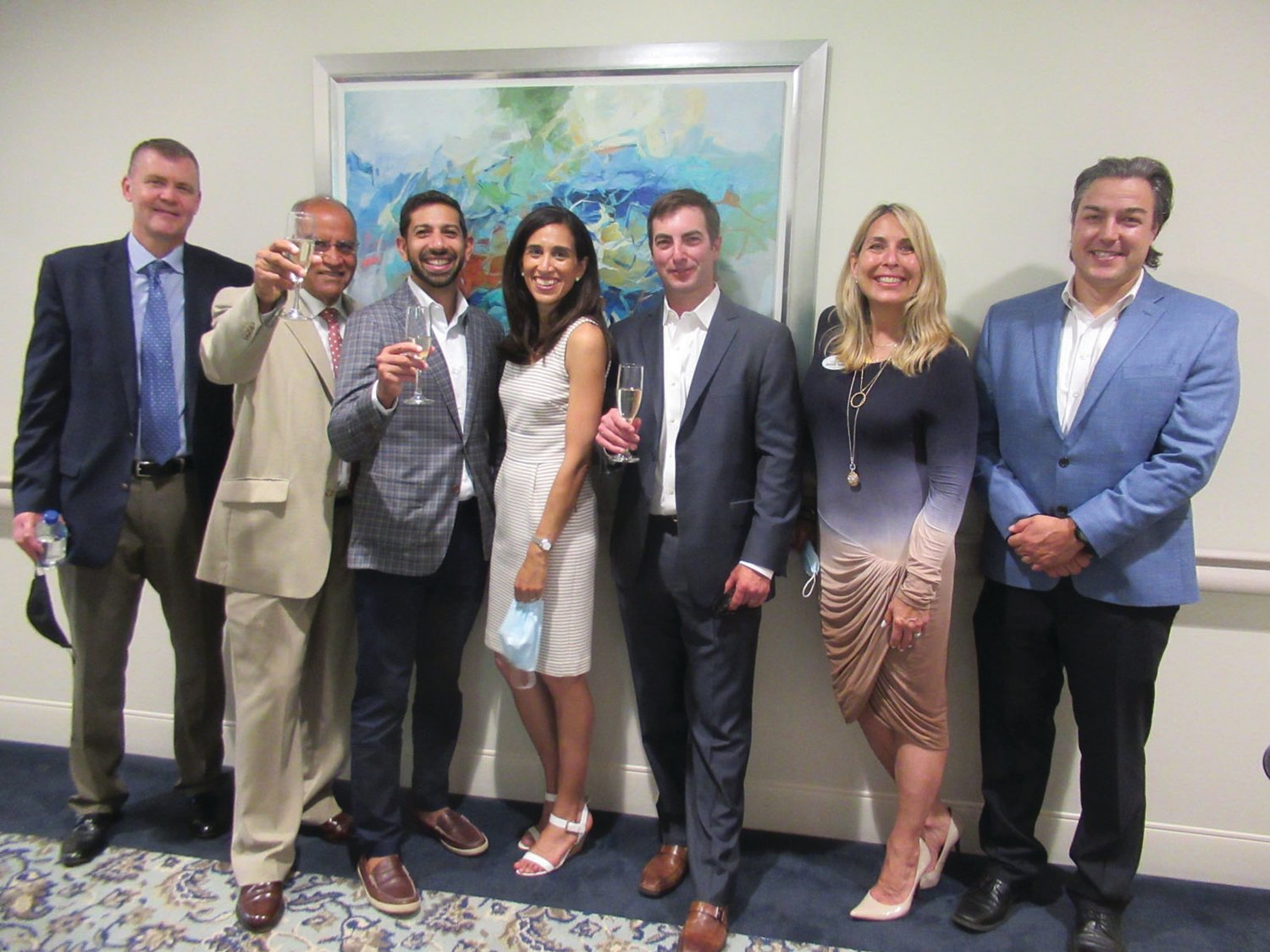 TERRIFIC TOAST: Briarcliffe CEO/President Akshay Talwar (second left) offers a toast during last week’s official opening of The Preserve. He’s joined by, from left: Patrick McAssey, Principal Clifton Larson Allen LLP, Anand Talwar, Nisha Talwar, Timothy Day, Stefany Reed and David Bodah, Executive Director of Rhode Island Living.